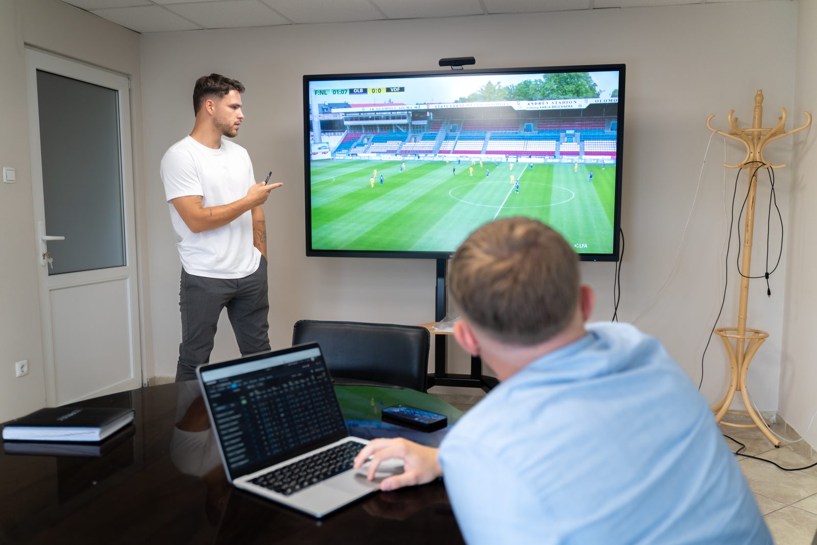 A lecturer analysing match footage